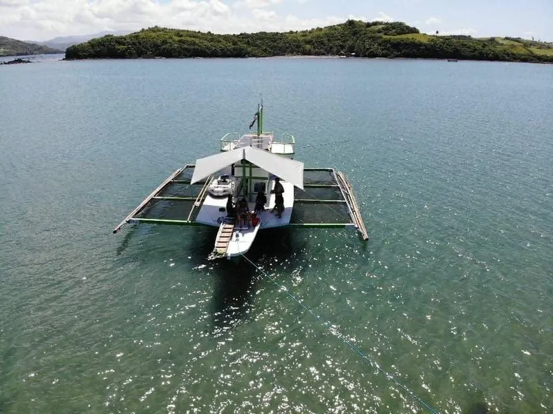 Aerial view of a 2016 Phinisi Custom Pleasure Cruiser or Dive Boat anchored in clear waters.
