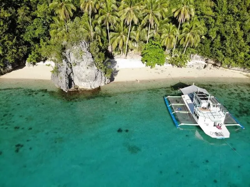 Aerial view of a 2016 Phinisi Custom Pleasure Cruiser or Dive Boat near a tropical beach.