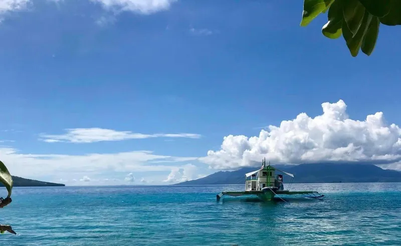 Phinisi Custom Pleasure Cruiser or Dive Boat 2016 on serene blue waters with a mountainous backdrop.