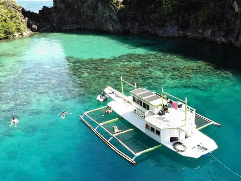 Aerial view of 2016 Phinisi Custom Pleasure Cruiser in clear turquoise waters.