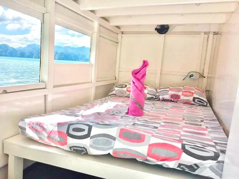 Cozy cabin interior of 2016 Phinisi Custom Pleasure Cruiser with scenic ocean view.