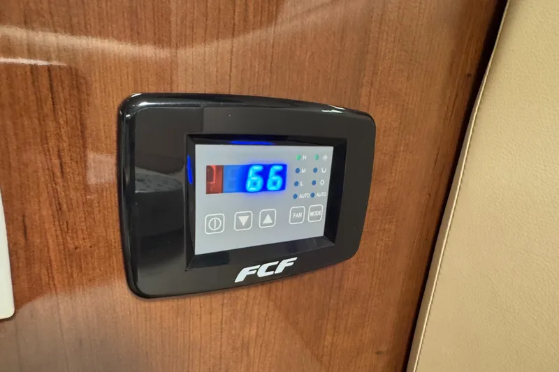 Digital control panel on 2016 Four Winns 255 Vista boat, displaying temperature.