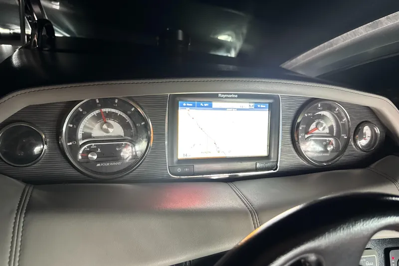 Dashboard of 2016 Four Winns 255 Vista boat with navigation display and gauges.