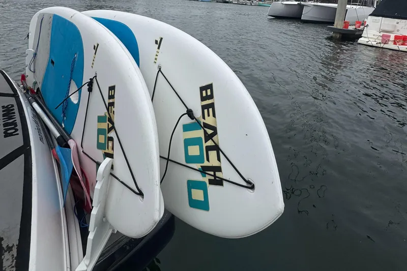 Two paddleboards on a 2016 Four Winns 255 Vista boat docked at a marina.