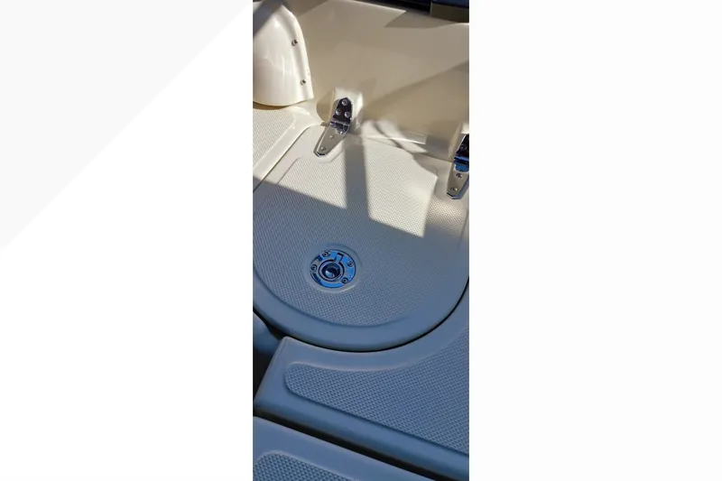 Deck detail of a 2002 Pacific Seacraft Dana 24 sailboat, featuring textured surface and hardware.