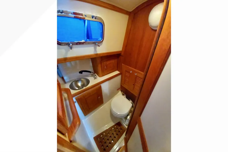 Compact wooden bathroom interior of 2002 Pacific Seacraft Dana 24 sailboat.