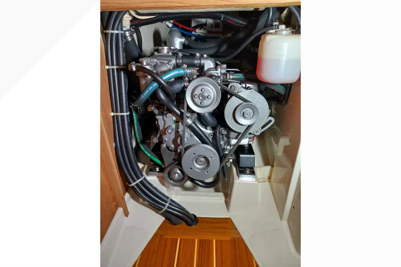 Engine compartment of a 2002 Pacific Seacraft Dana 24 sailboat, showcasing mechanical components.