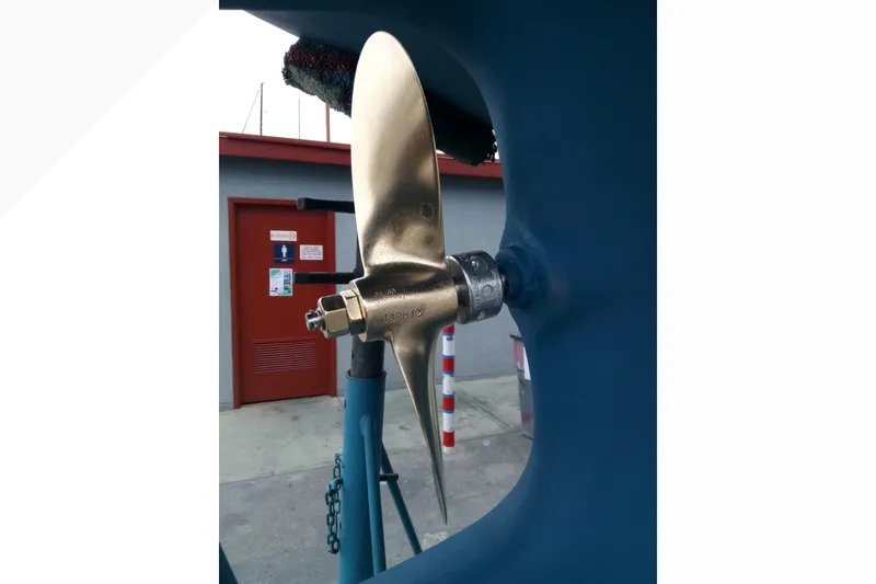 Close-up of a 2002 Pacific Seacraft Dana 24 boat propeller in a shipyard.