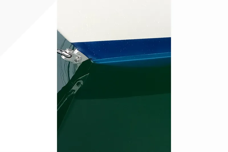 Close-up of a 2002 Pacific Seacraft Dana 24 boat hull with blue and white detailing.