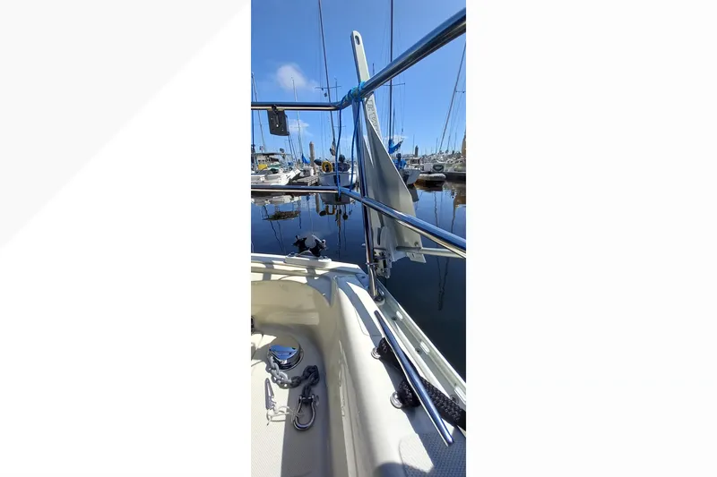 2002 Pacific Seacraft Dana 24 sailboat docked in a marina, showcasing deck details.