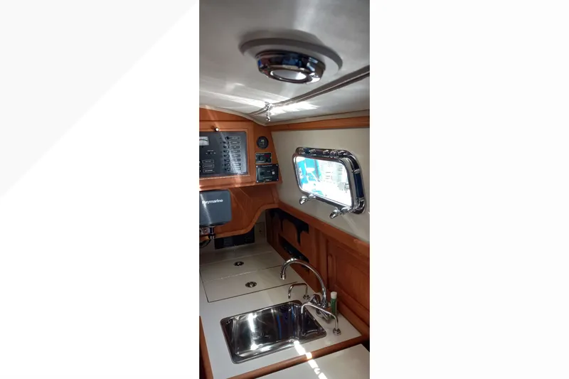 Interior of 2002 Pacific Seacraft Dana 24 sailboat, featuring a compact galley with sink.