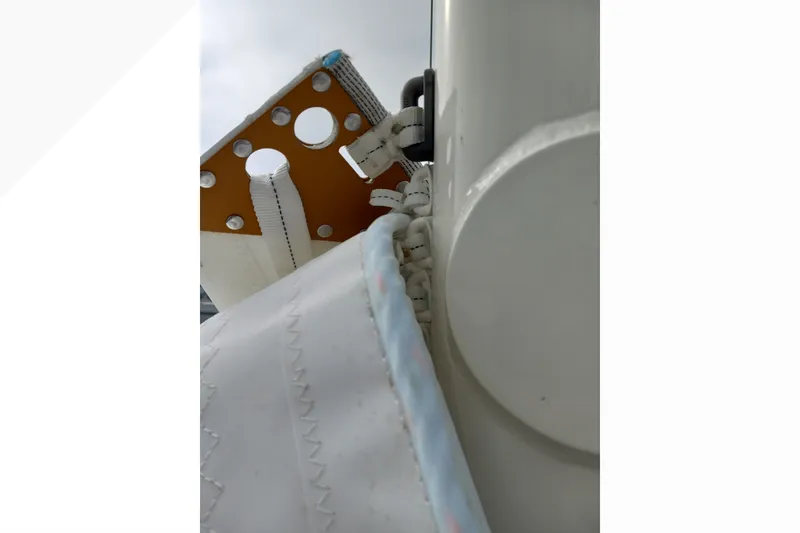 Close-up of Pacific Seacraft Dana 24 sailboat rigging, showcasing detailed stitching and hardware.