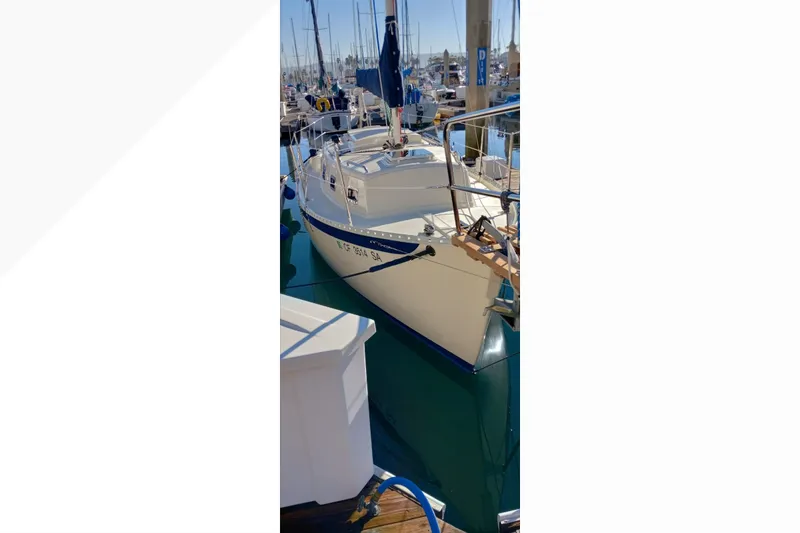 2002 Pacific Seacraft Dana 24 sailboat docked in a marina, sunny day.