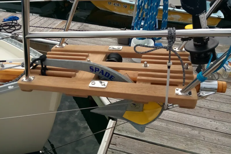 Pacific Seacraft Dana 24 sailboat anchor setup, featuring a Spade anchor on a wooden mount.