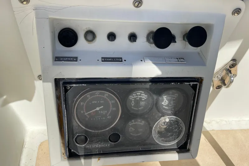 Control panel of a 1978 Downeast 38 boat with gauges and switches.
