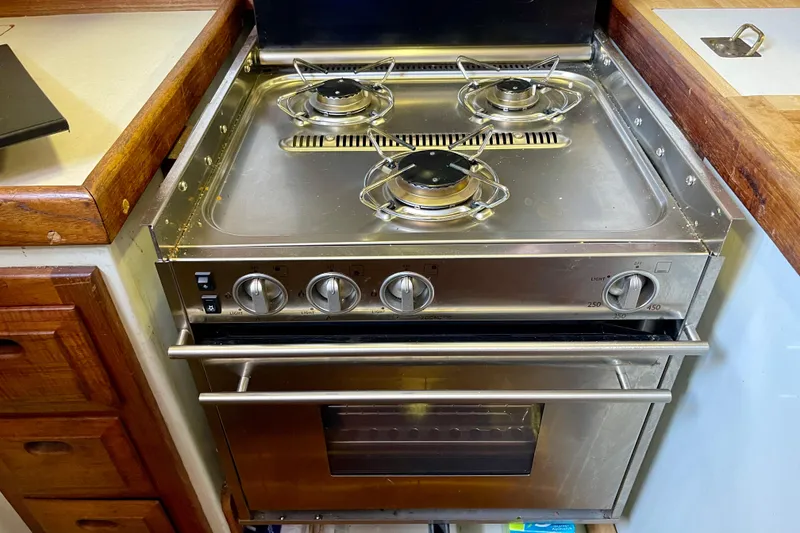 Stainless steel stove and oven in a 1978 Downeast 38 boat kitchen.