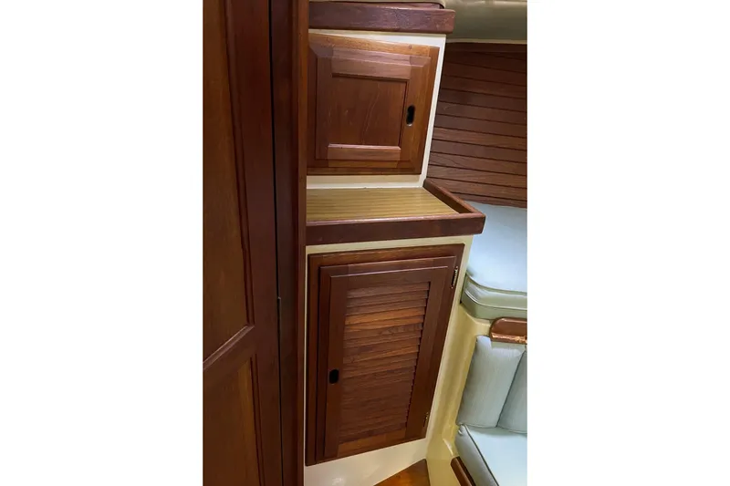 1978 Downeast 38 yacht interior with wooden cabinets and seating area.