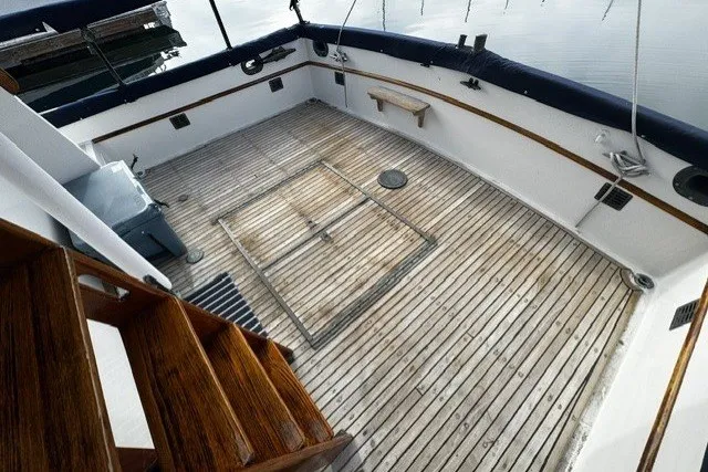 1974 Grand Banks 32 Sedan boat deck with wooden flooring and stairs.