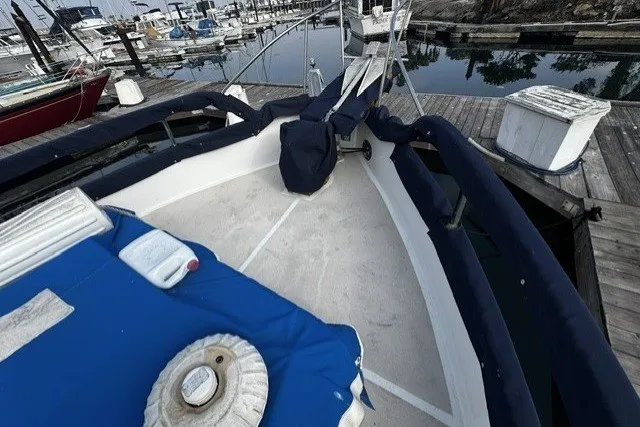1974 Grand Banks 32 Sedan boat docked at marina with blue covers.