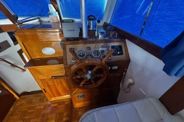 1974 Grand Banks 32 Sedan helm with wooden steering wheel and navigation instruments.