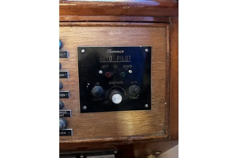1974 Grand Banks 32 Sedan autopilot control panel with wooden finish and labeled buttons.