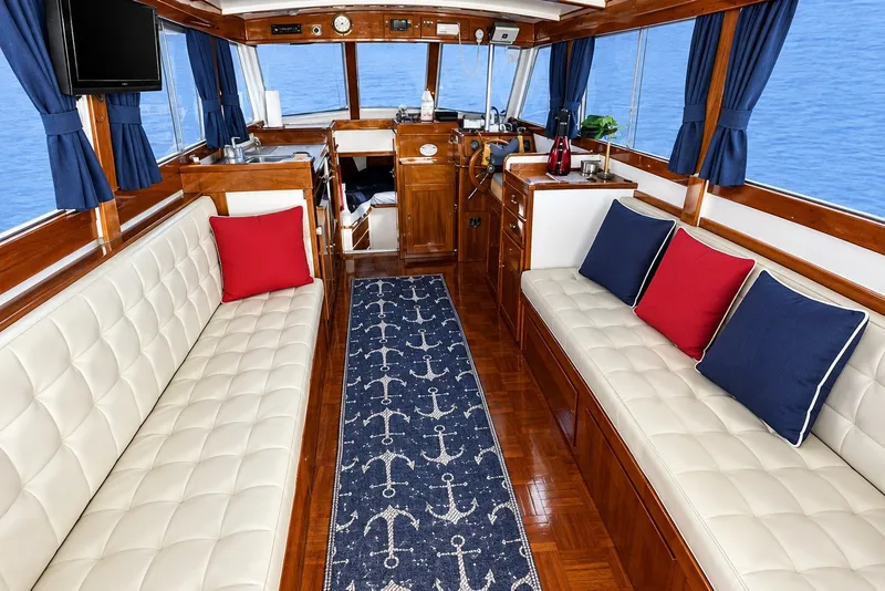 Interior of a 1974 Grand Banks 32 Sedan with nautical decor and plush seating.