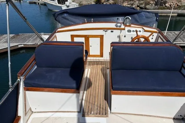 1974 Grand Banks 32 Sedan boat interior with blue seating and wooden accents.