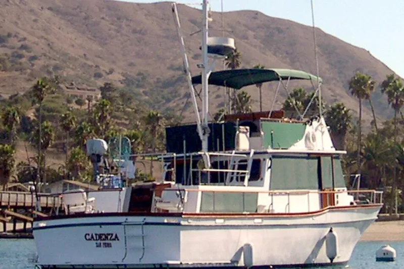 1978 Californian 42 LRC yacht anchored near scenic palm-lined coastline.