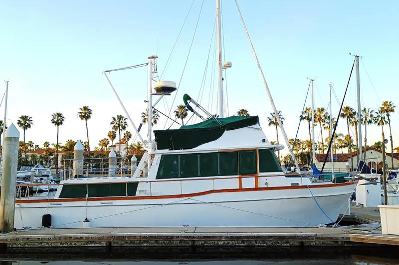 1978 Californian LRC yacht docked at marina with palm trees in background.