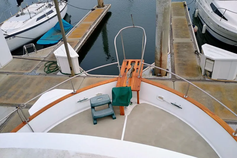 1978 Californian LRC yacht docked at marina, featuring wooden deck and mooring equipment.