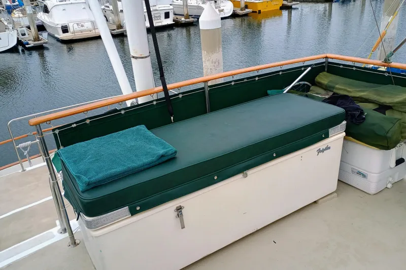 1978 Californian LRC boat deck with green cushions and marina view.