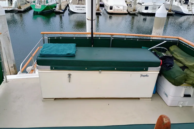 1978 Californian LRC boat deck with storage bench and marina view.
