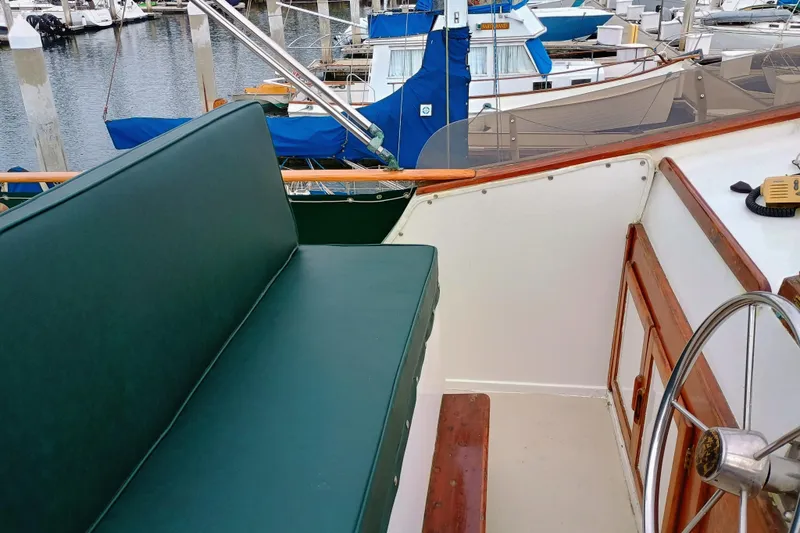 1978 Californian LRC boat interior with green seating and wooden steering wheel.