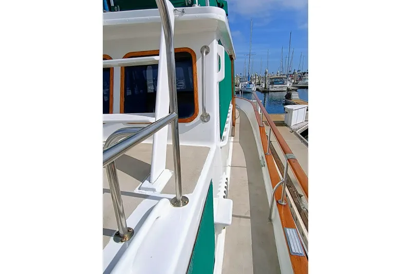 1978 Californian LRC yacht deck with stainless steel railings, docked at marina.
