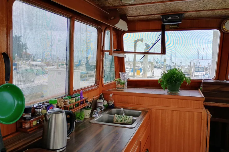 1978 Californian LRC boat interior with kitchen, plants, and marina view.