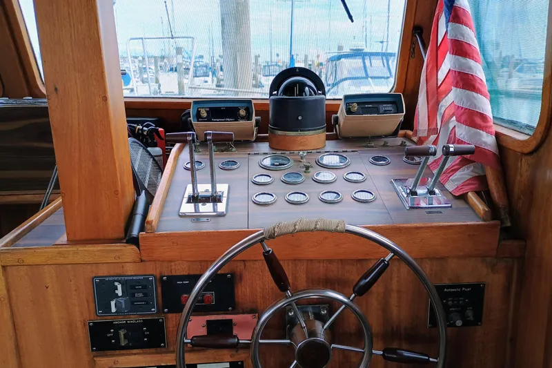 1978 Californian LRC boat helm with wooden dashboard, steering wheel, and American flag.