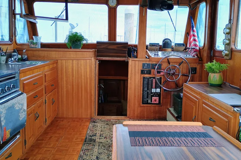 1978 Californian LRC boat interior with wooden cabinetry, steering wheel, and American flag.