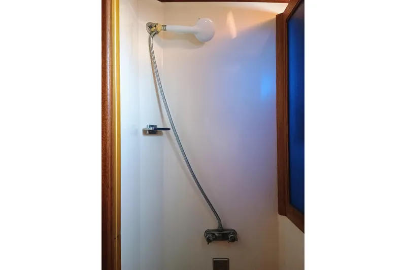 1978 Californian LRC shower with flexible hose and wooden trim.