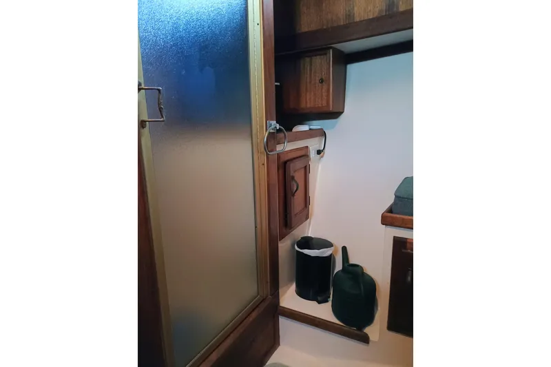 1978 Californian LRC interior with wooden cabinets and frosted glass door.