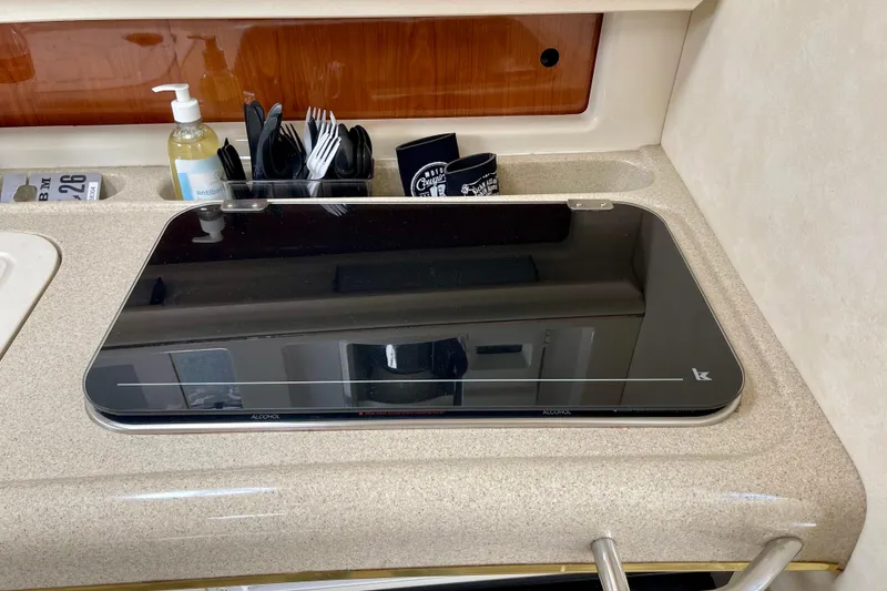 Kitchen area of a 2000 Monterey 302 Cruiser with stove and utensils.