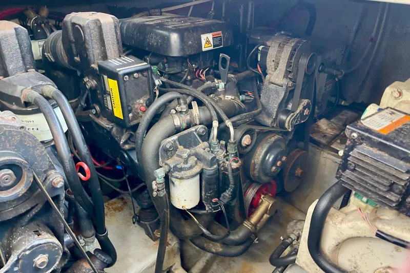 Engine compartment of a 2000 Monterey 302 Cruiser boat, showcasing mechanical components.