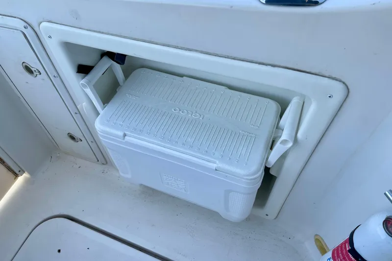 White cooler stored on a 2000 Monterey 302 Cruiser boat deck compartment.