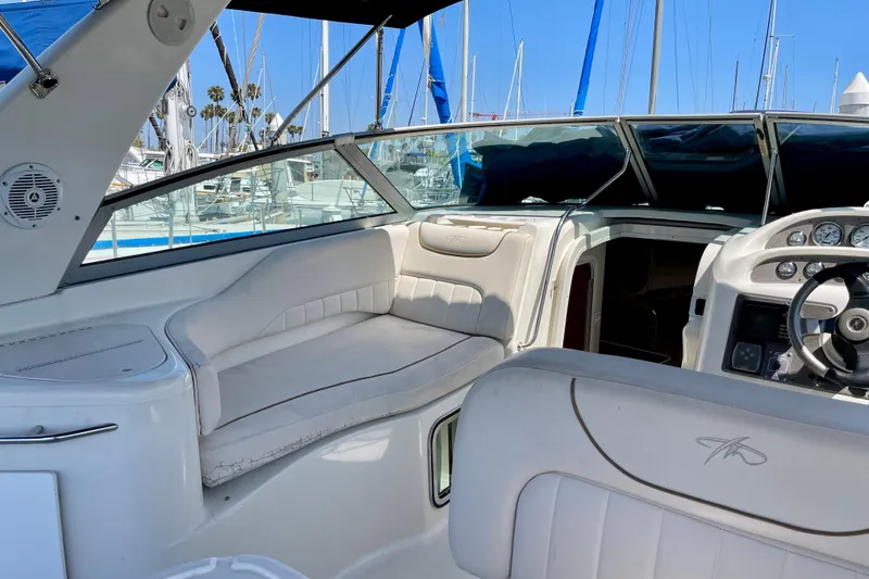 Interior view of a 2000 Monterey 302 Cruiser boat with white seating and dashboard.