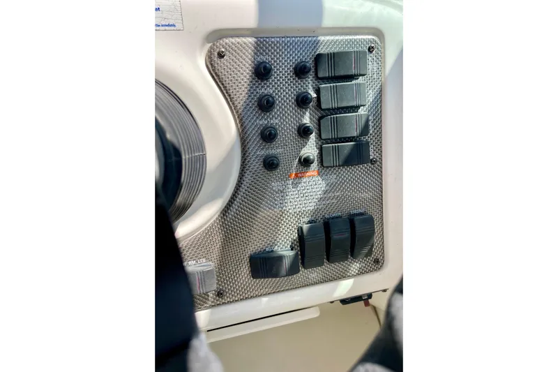 Control panel of a 2000 Monterey 302 Cruiser boat with switches and buttons.