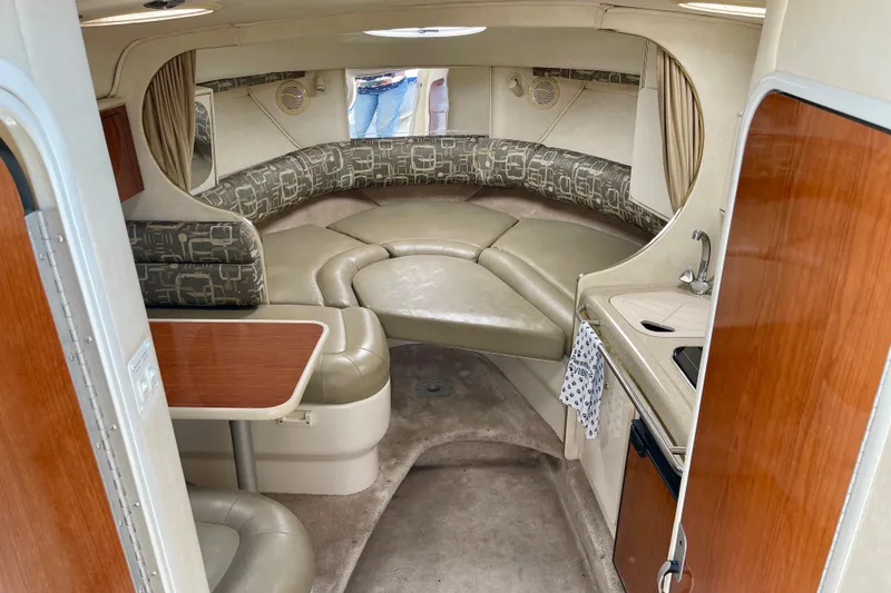 Interior of a 2000 Monterey 302 Cruiser boat with seating and kitchenette.
