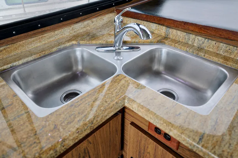Double stainless steel sink with granite countertop on 1980 Pacifica 41 Sportfisher.