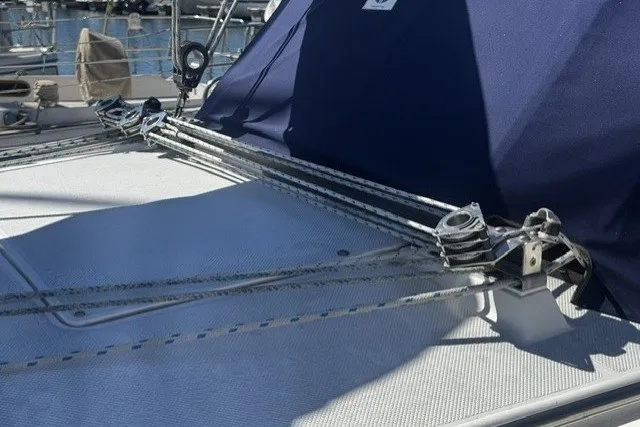 Rope rigging on a 2000 Catalina 320 sailboat deck, featuring a blue canopy.