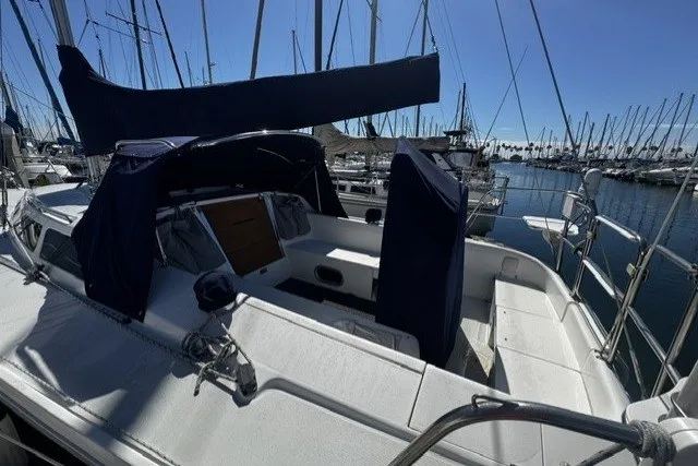 Sailboat Catalina 320, year 2000, docked in a marina under clear blue skies.