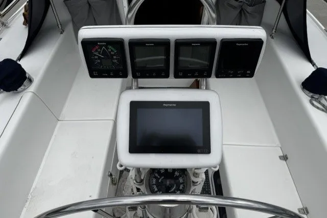 Cockpit of 2000 Catalina 320 sailboat with navigation instruments and steering wheel.