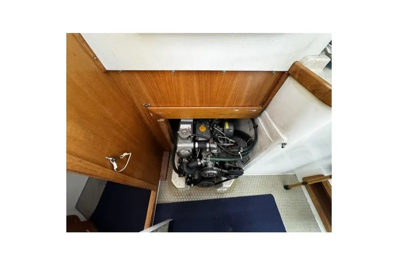 Engine compartment of a 2000 Catalina 320 sailboat, featuring a compact marine engine.
